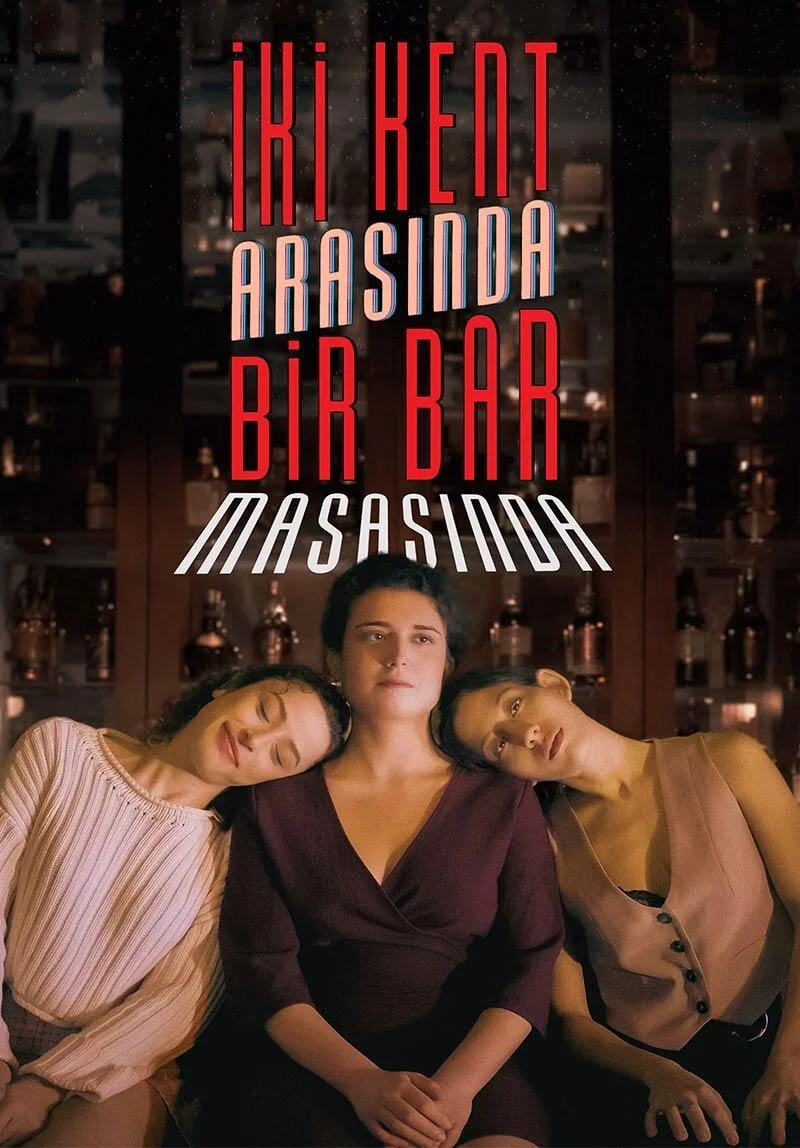İki Kent Arasında Bir Bar Masasında